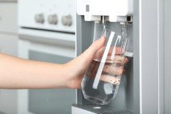 Woman,Filling,Glass,With,Water,Cooler,Indoors,,Closeup.,Refreshing,Drink