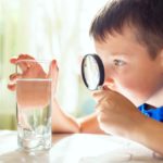 The,Child,Boy,Looking,At,Water,In,A,Glass,Through