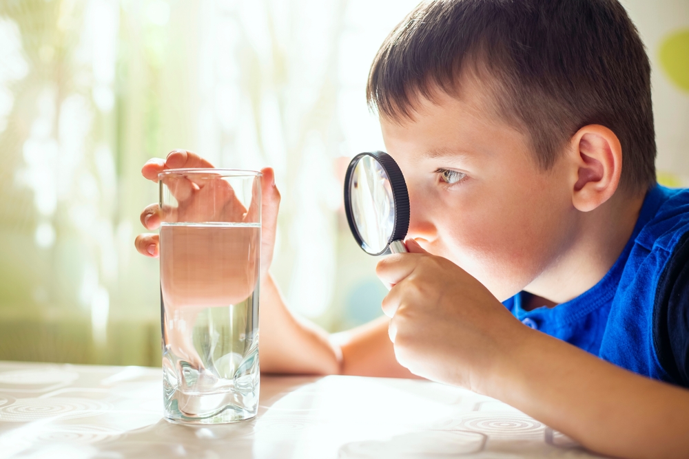 The,Child,Boy,Looking,At,Water,In,A,Glass,Through